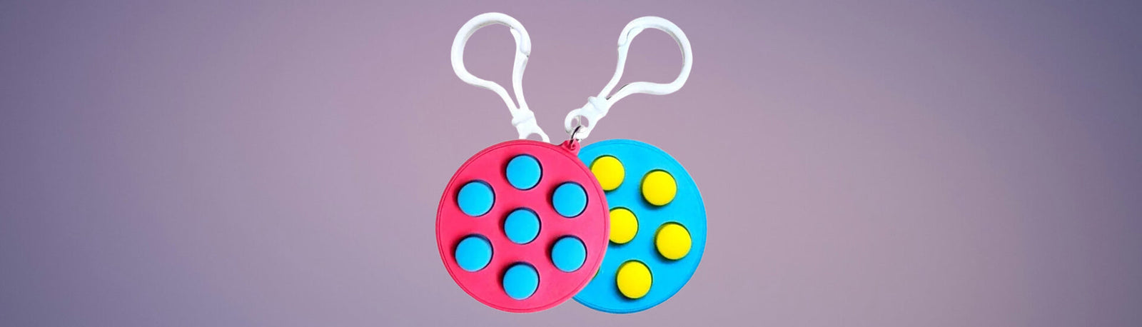 2 fidget clickers on a gradient purple background-fun fidgets