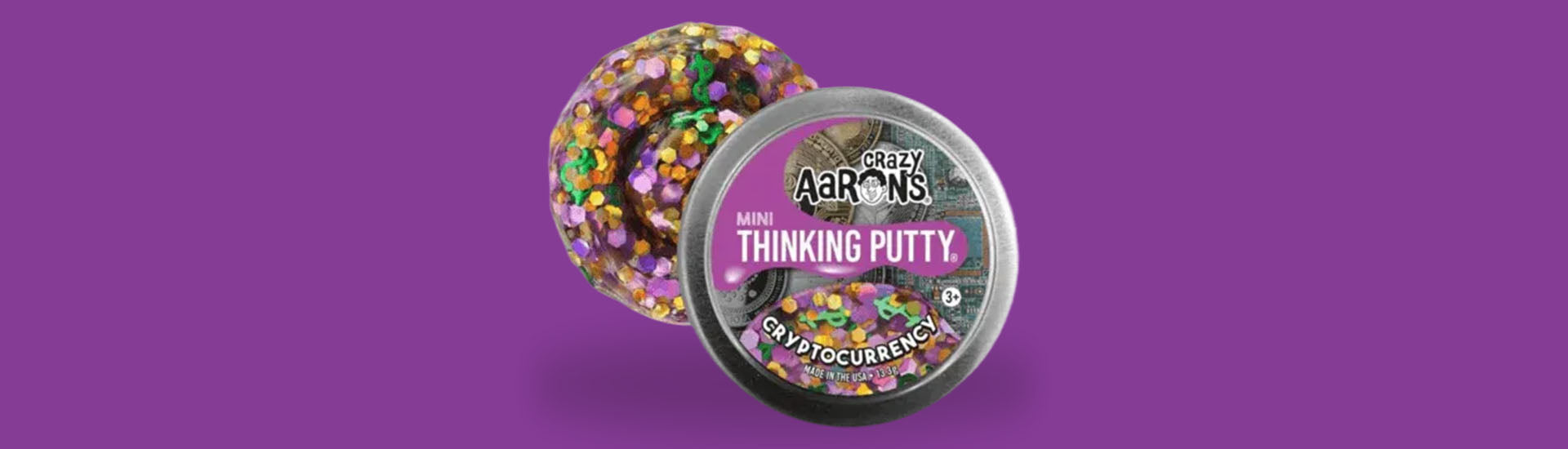 a 2 inch cryptocurrency crazy aarons thinking putty tin on a purple background-fun fidgets