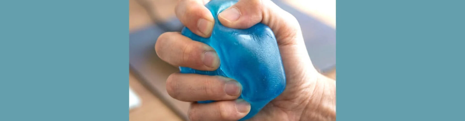 a blue squishy toy being squeezed on a blue background-fun fidgets