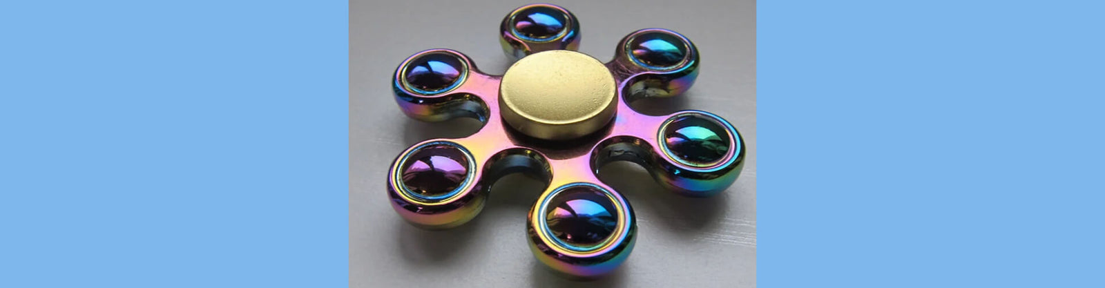 metallic fidget spinner on a grey background-fun fidgets