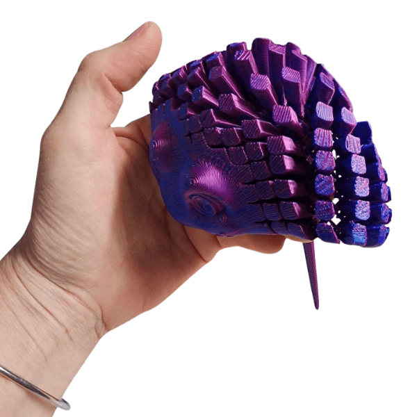 blue 3D Printed Articulated Stingray shown draped over a hand-fun fidgets