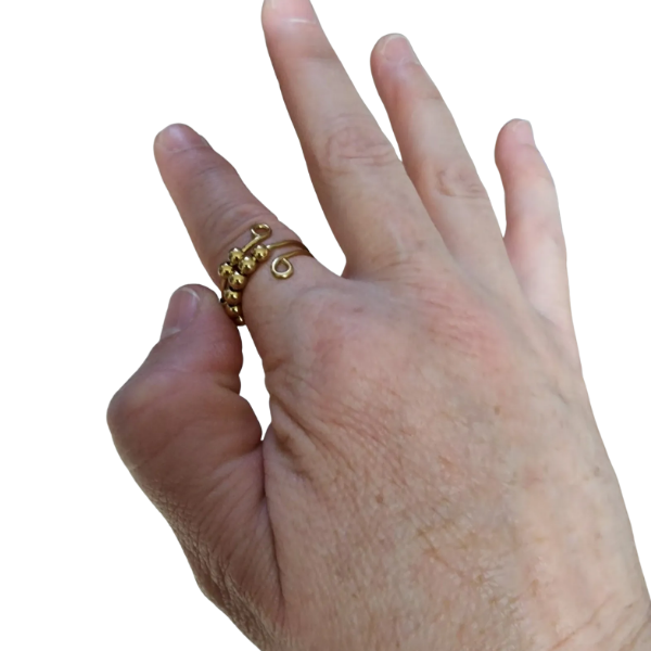gold fidget ring shown on a finger being fidgeted with-fun fidgets