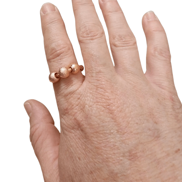 3 bead fidget ring-rose- shown being worn-fun fidgets