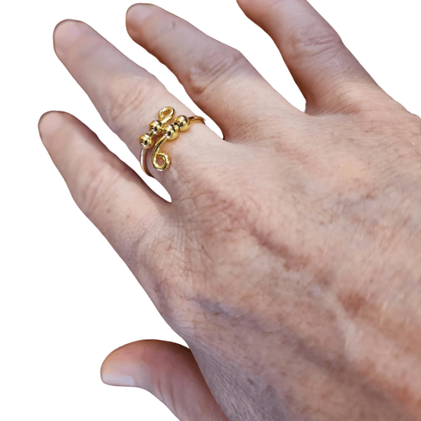 gold 4 bead fidget ring shown on a hand-fun fidgets