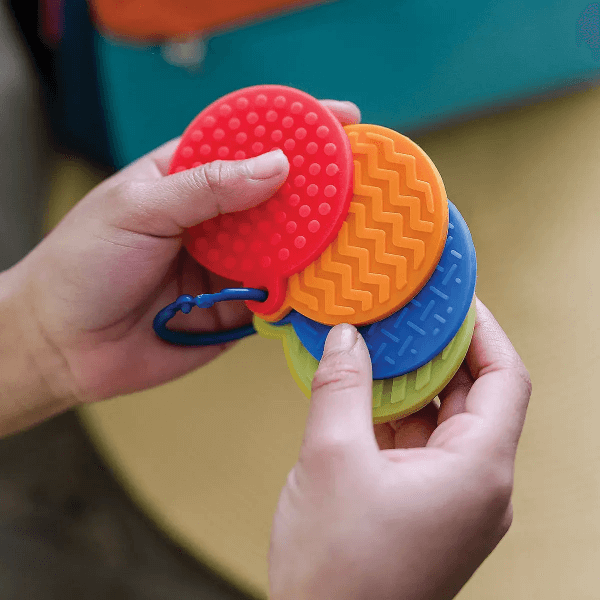 mini sensory genius sensory mats being held in a persons hands-fun fidgets