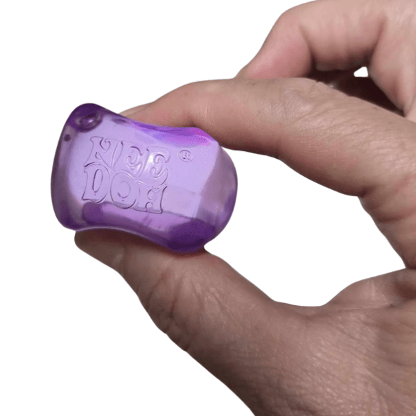 purple Nee Doh Nice Ice Baby being squeezed between 2 fingers-fun fidgets 