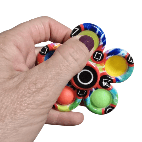 pop it spinner shown with the bubbles being popped-fun fidgets