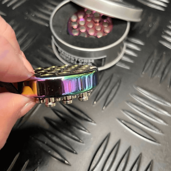 Rainstorm Necklace-Wearable Sensory Support shown in the tin and one out of the tin held in a hand-fun fidgets
