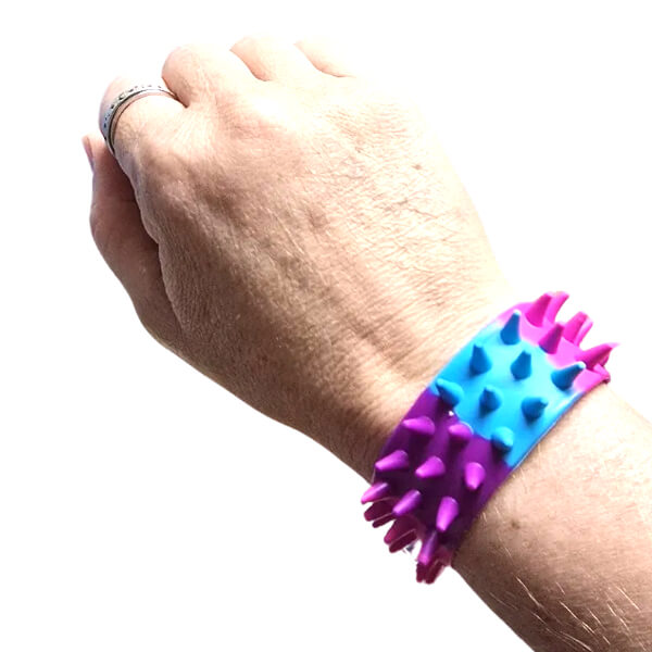 Hand wearing a colourful bracelet with spiky texture on a white background-fun fidgets