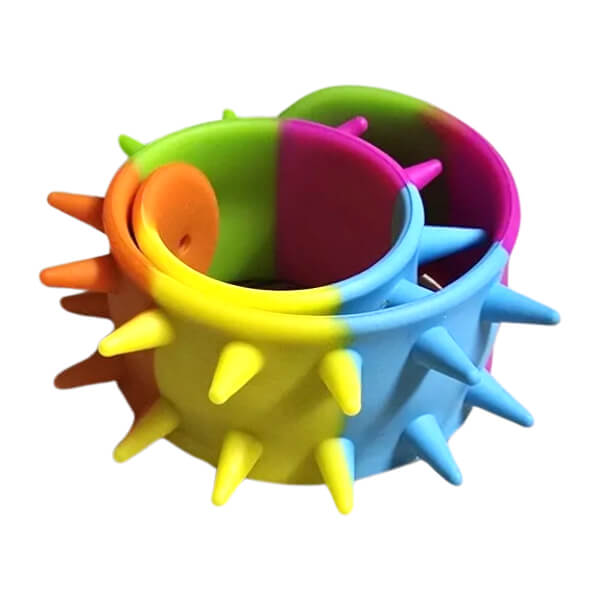 Colourful spiky snap band coiled up with multiple colours on a white background-fun fidgets