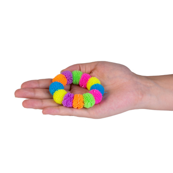 squishy pom pom bracelet shown held on a hand-fun fidgets